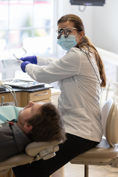 Dr. Campos providing cosmetic dental care for a patient at Cochituate Smile Center