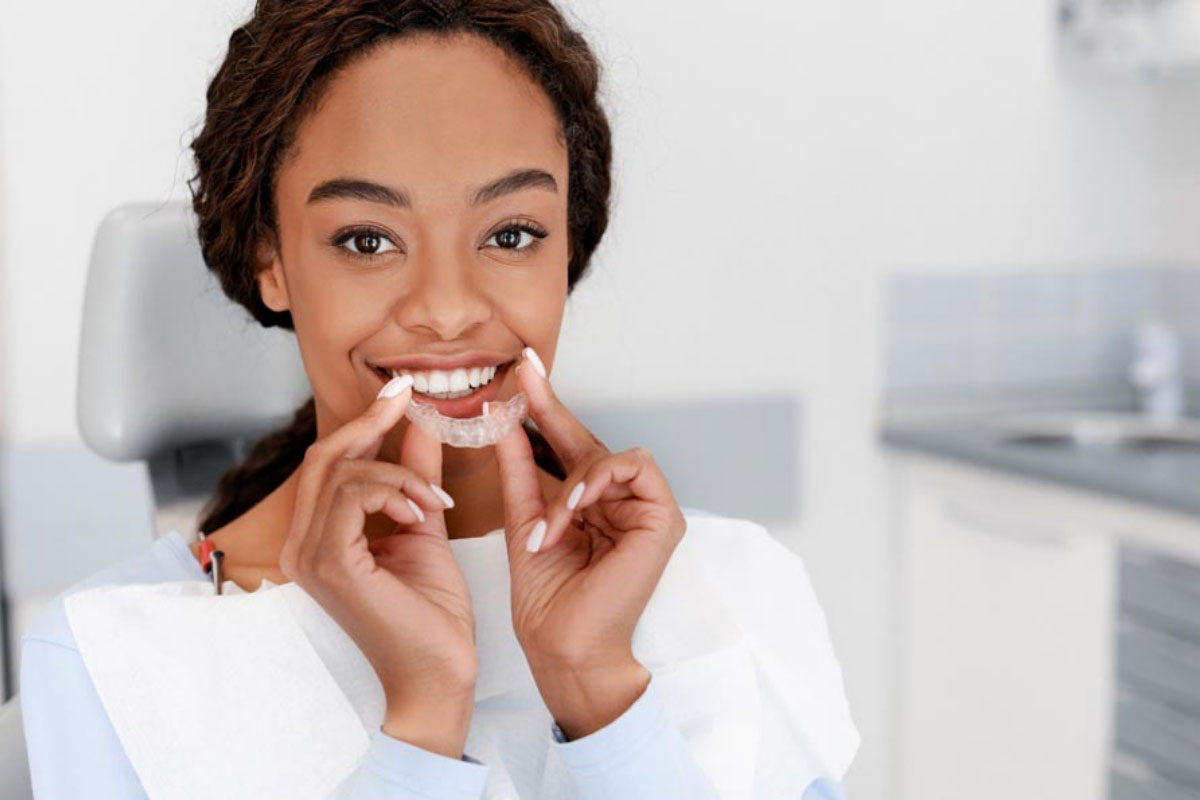 woman putting in new Invisalign clear aligners