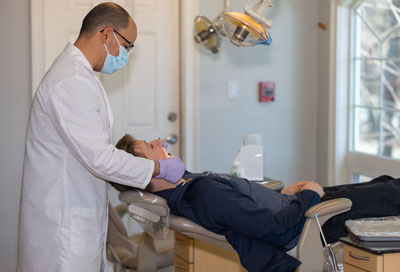 Dr. Campos providing periodontal care for a patient at Cochituate Smile Center