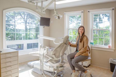 Dr. Belussi-Campos inside of the dental exam room at Cochituate Smile Center